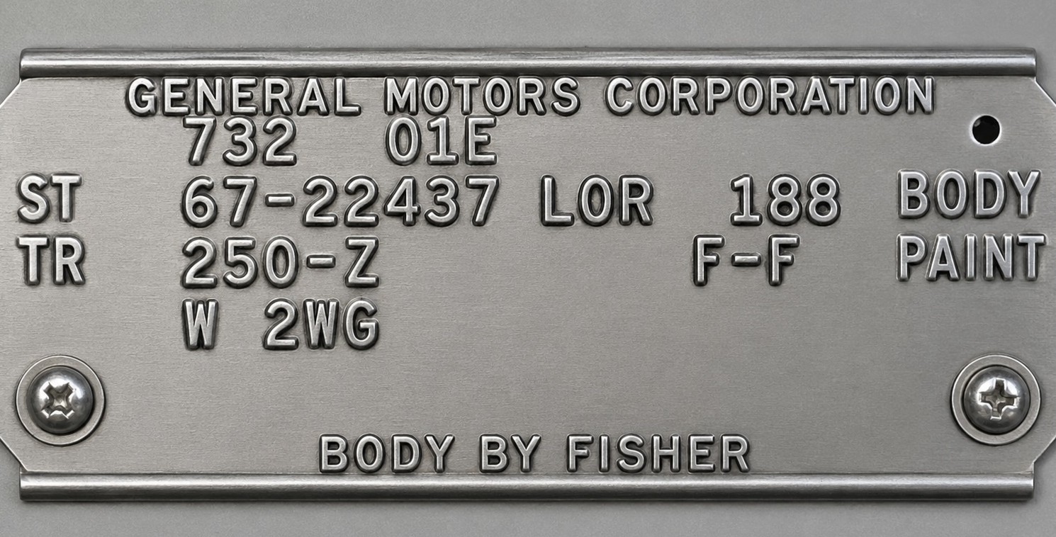 An original 1967 Pontiac Firebird Fisher body (cowl) tag riveted to the firewall